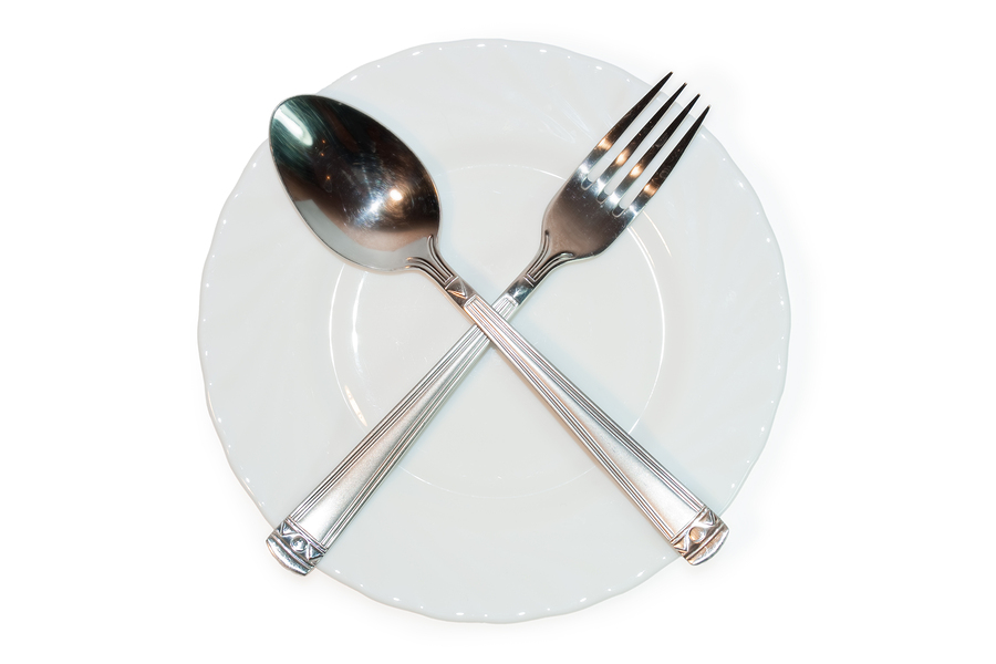 Fork And Spoon Crossed On Plate